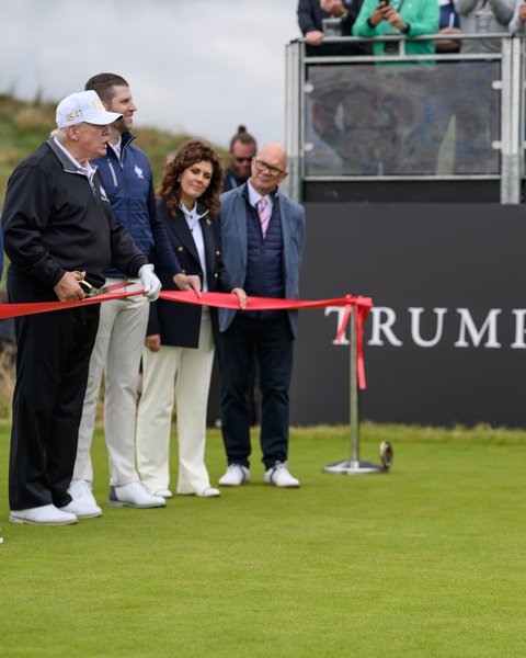 Trump cuts a ribbon at the opening of the new course at Trump International Golf Links Aberdeen, July 2025